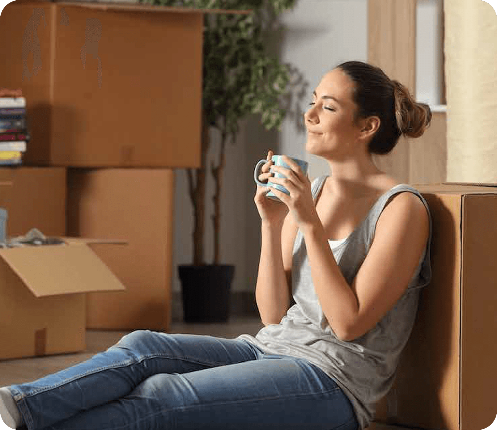 Person smiling while drinking coffee with boxes around them