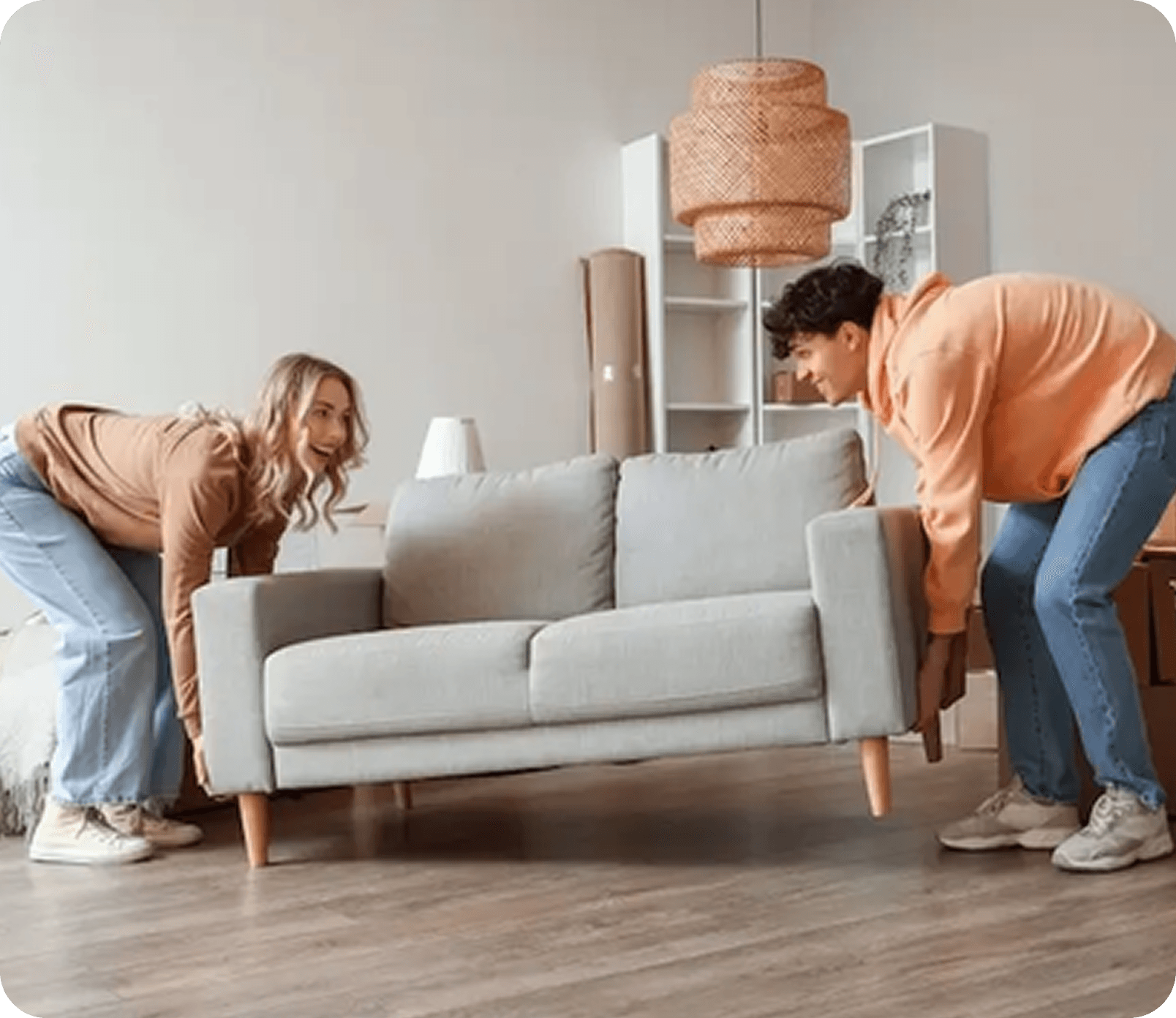 Two people lifting a couch