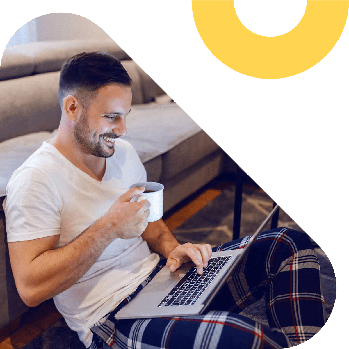 Person drinking coffee and smiling while using a laptop